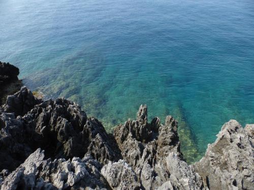 a view of the ocean from a rocky shore at Hotel Villa Degli Aranci in Maratea