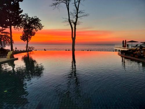 a swimming pool with a tree in the middle of the ocean at Chang Buri Resort & Koh Chang Hillside in Ko Chang