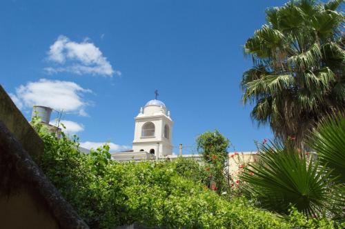 a white building with a tower on top of it at Rutas Hotel in Salta