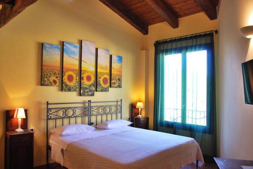 a bedroom with a white bed and a window at Il Murello in Fiorentina