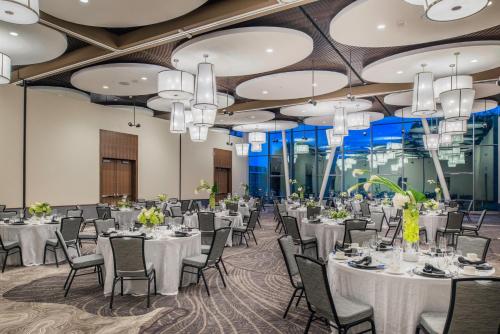 a banquet hall with tables and chairs and chandeliers at The Hotel at Oberlin in Oberlin