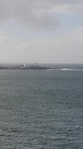 a large body of water with a ship in the distance at Horizon View Lodge Bed and Breakfast Glanleam Road Knightstown Valentia Island County Kerry V23 W447 Ireland in Valentia Island