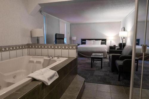 a hotel room with a bath tub and a bed at Coast High Country Inn in Whitehorse