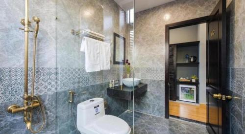 a bathroom with a toilet and a shower at Friendly Villa Hoian in Hoi An