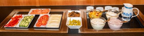 a tray with different types of food on a table at Hotel-Restaurant Gasthaus Bonimeier in Niedergottsau