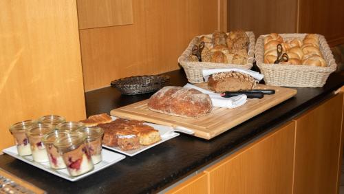 a counter topped with bread and baskets of pastries at Hotel-Restaurant Gasthaus Bonimeier in Niedergottsau