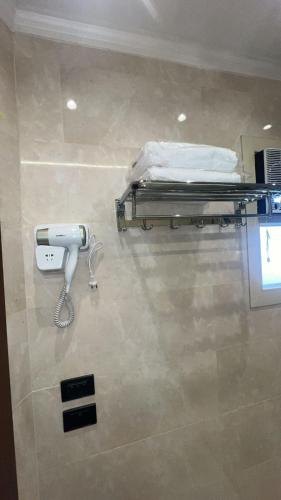 a hospital room with a bed and a phone at Doki sky suite in Cairo