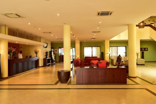 a lobby of a hospital with columns and furniture at Pestana Sao Tome in São Tomé