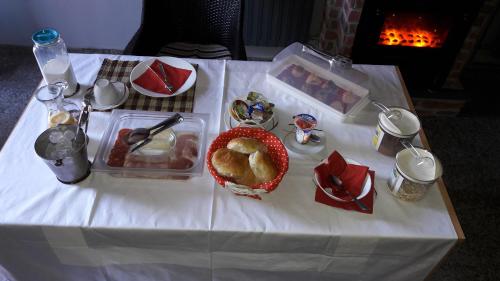 a table with a white table cloth with food on it at Hostel IN Club in Zagreb