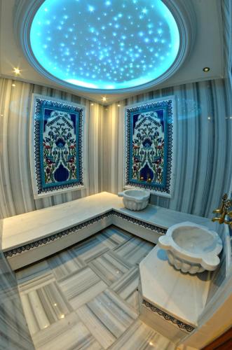 a bathroom with a toilet and a star ceiling at AMARA OLD CITY HOTEL & Spa in Istanbul