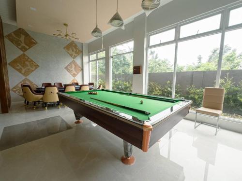 a billiard room with a pool table and chairs at Highland Villas Royale Corp in Alfonso
