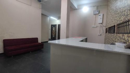 a room with a counter and a red chair at Hotel O by OYO RASRANG in Raipur