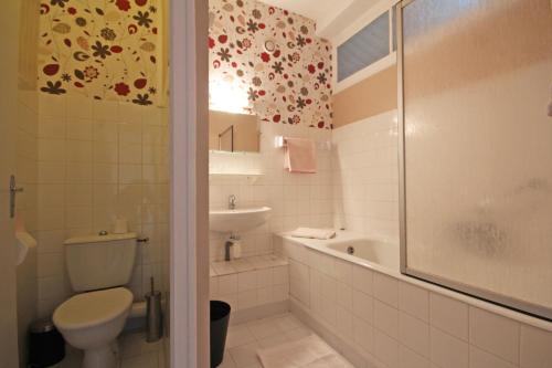 a bathroom with a toilet and a sink and a shower at Gite Le Relais Saint Michel in Domfront