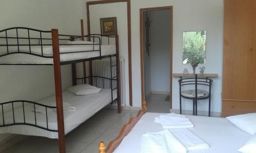 a room with two bunk beds and a bathroom at Anastasia in Áno Lekhónia