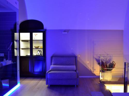 a purple room with a chair and a shelf at Maga Mirì Relais Suite in Spinazzola