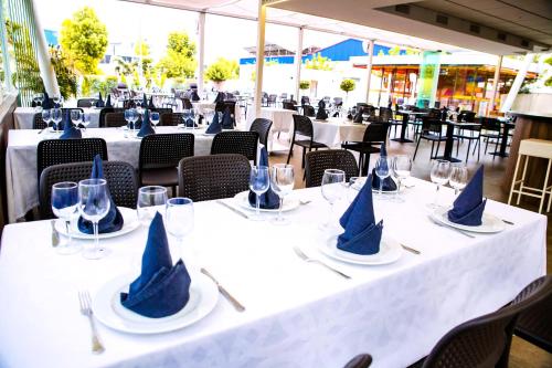a white table with blue napkins on top of it at Hotel Villa Ceuti in Ceuti
