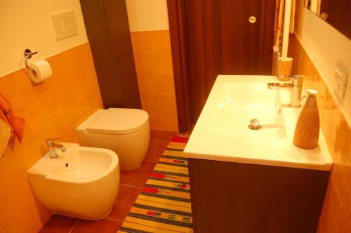 a bathroom with a white sink and a toilet at Masseria Convento in Novoli