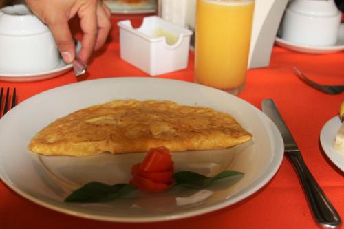 a white plate with a pie on a table at La Posada del Arcangel in Managua