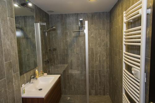 a bathroom with a sink and a shower at Chalet du Saix in Châtel
