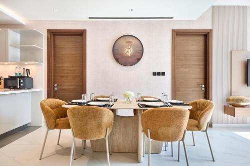 a dining room with a table and chairs at STAY BY LATINEM Luxury 3BR Holiday Home CA 0702 Near Burj Khalifa in Dubai