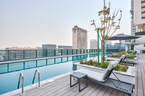 a pool on the roof of a building at STAY BY LATINEM Luxury 3BR Holiday Home CA 0702 Near Burj Khalifa in Dubai