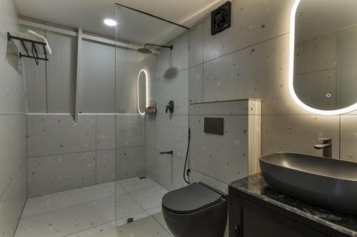 a bathroom with a sink and a toilet at Triangle Valley in Ooty