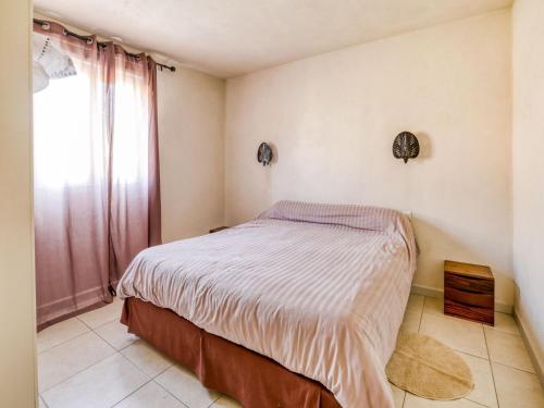 a small bedroom with a bed and a window at Cosy holiday home in Tuscany with shared swimming pool in San Casciano in Val di Pesa