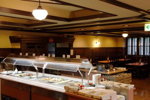 a restaurant with a buffet line with food at Hakuba Hotel Paipu no Kemuri in Hakuba