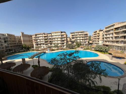 a view of two swimming pools from a balcony at Studio pearl pyramids in Ghaţāţī