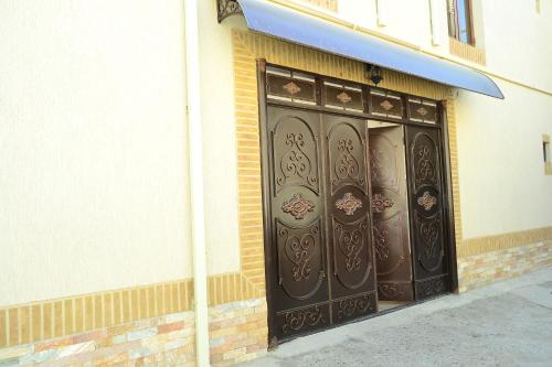 a pair of doors on the side of a building at Hotel Nazira & Azizbek in Bukhara