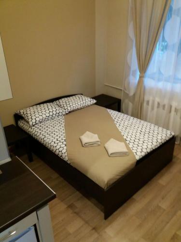 a bedroom with a bed with two towels on it at Apartment na Stanislavskogo in Novosibirsk