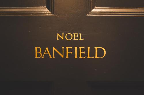 a sign that reads noel balittied on a door at Hotel Palisade in Sydney