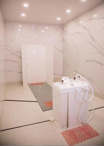 a white bathroom with a sink and a mirror at Green Wellness Burabay in Borovoye