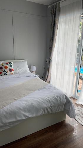 a bedroom with a bed and a large window at Home stay Ev Coffeehouse in Ban Map Khao Wan