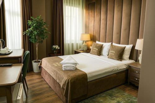 a bedroom with a large bed in a hotel room at Parliament Hotel & Restaurant in Baku