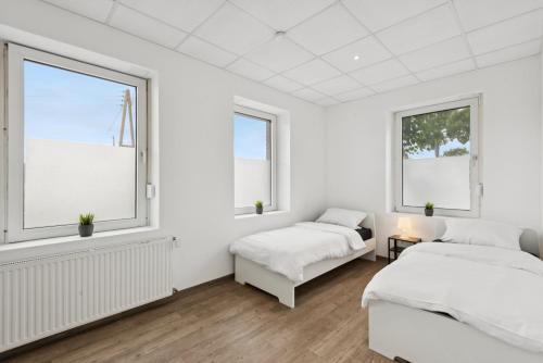 En eller flere senge i et værelse på Worker Place Bedburg Hau