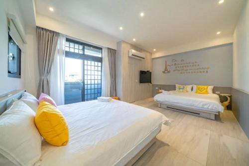 Postel nebo postele na pokoji v ubytování 愛旅行民宿 可包棟