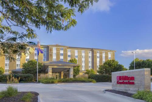 a building with a sign in front of it at Hilton Garden Inn Des Moines/Urbandale in Urbandale