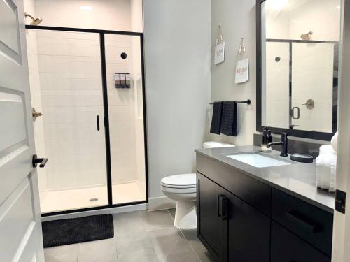 a bathroom with a shower and a toilet and a sink at The Deep Ellum Serenity Suite in Dallas