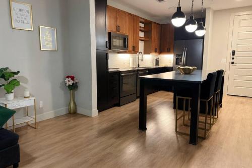 a kitchen with a black table in a room at The Deep Ellum Serenity Suite in Dallas