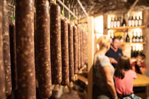 a group of people standing in a wine cellar at Holiday Home Pr'Lukčevih with 4 Bedrooms & Sauna in Kanal
