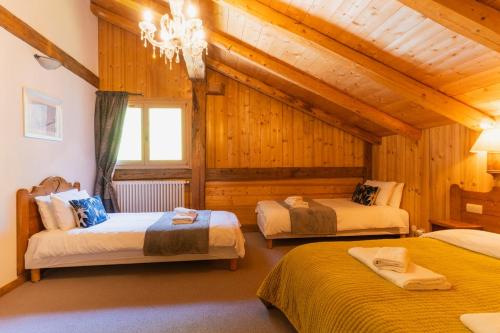 En eller flere senge i et værelse på La Ferme a Mamy - Snowytrees