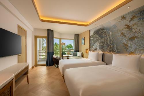 Ένα ή περισσότερα κρεβάτια σε δωμάτιο στο Mövenpick Resort & Spa Bintan Lagoon