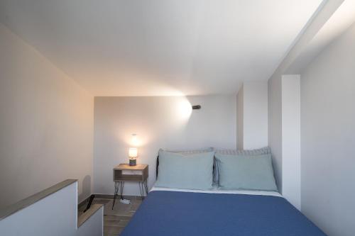 a bedroom with a blue bed and a side table at Panorama Sunvilles Apartment 9 in Thessaloniki