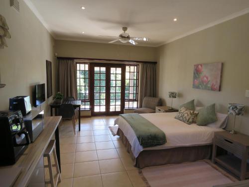a bedroom with a bed and a living room at Home on Haven Hill in Durban