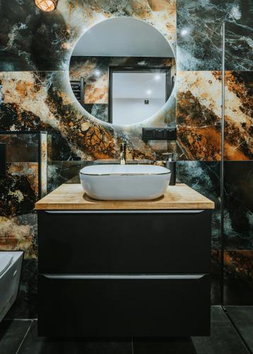 a bathroom with a sink and a mirror at Willa przy Krupówkach Apartments & Rooms Villa Heart of the Mountains Zakopane in Zakopane