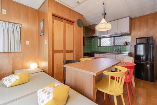 a kitchen with a table and some yellow chairs at NOKA stay MIZUE - オープン特別価格, 最大6名貸切, 浅草 東京 銀座 上野 30分, ディズニー 新宿 渋谷40分 in Tokyo