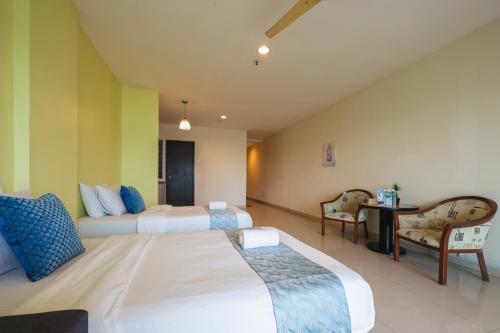 En eller flere senge i et værelse på Marina Island Lumut Homestay