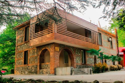 a large brick building withwindows at Wald Hotel Lagodekhi in Lagodekhi