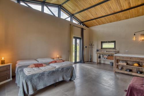a large bedroom with two beds and a fireplace at Tuscan Cozy Escape with View, Garden & Breakfast in CastellʼAzzara